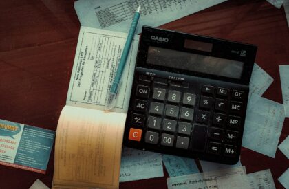 Photo by FIN a calculator sitting on top of a wooden table