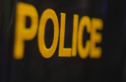 a close up of a police badge on a black background