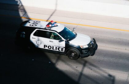 Photo by Wesley Tingey a police car parked on the side of the road